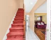 Stairs featuring tile patterned flooring, arched walkways, and baseboards