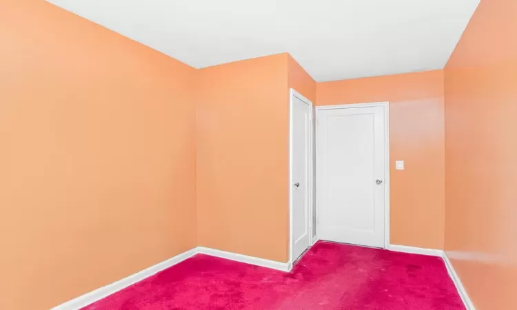 Carpeted spare room with baseboards