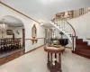 Entrance foyer featuring arched walkways, a notable chandelier, and stairs