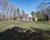 Back of house featuring a gazebo, a chimney, and a yard