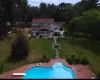 View of pool featuring a lawn, a patio, fence, a diving board, and a fenced in pool