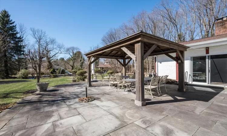 View of patio with a gazebo and outdoor dining area