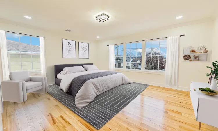 Bedroom with hardwood / wood-style flooring, ornamental molding, and multiple windows