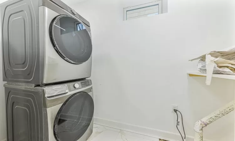 Washroom featuring stacked washer and dryer