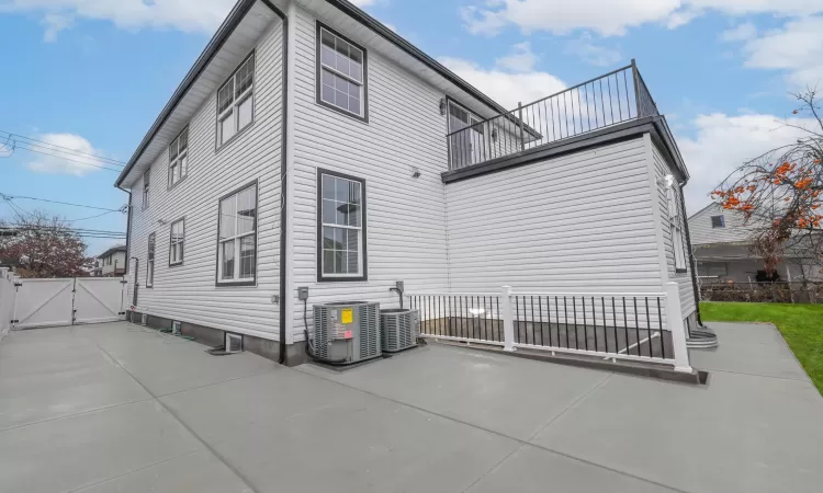 View of property exterior featuring a patio area, a balcony, and central air condition unit