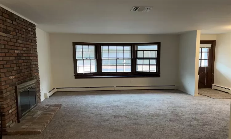 Living room, a fireplace, and brand new carpet flooring