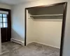 Entry way with hard floor meeting carpet and a large coat closet