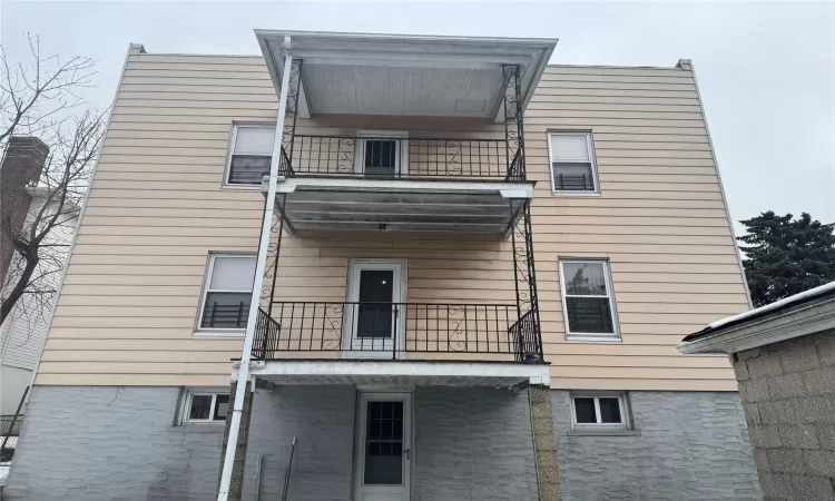 Back of house featuring a balcony