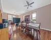 Dining space with hardwood / wood-style floors, a ceiling fan, baseboards, and ornamental molding