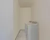 Laundry room featuring independent washer and dryer, light tile patterned flooring, and laundry area