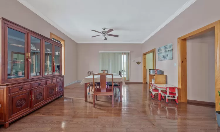 Dining area with ceiling fan, baseboards, wood finished floors, and ornamental molding