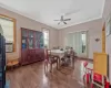 Dining area featuring ceiling fan, ornamental molding, and hardwood / wood-style flooring