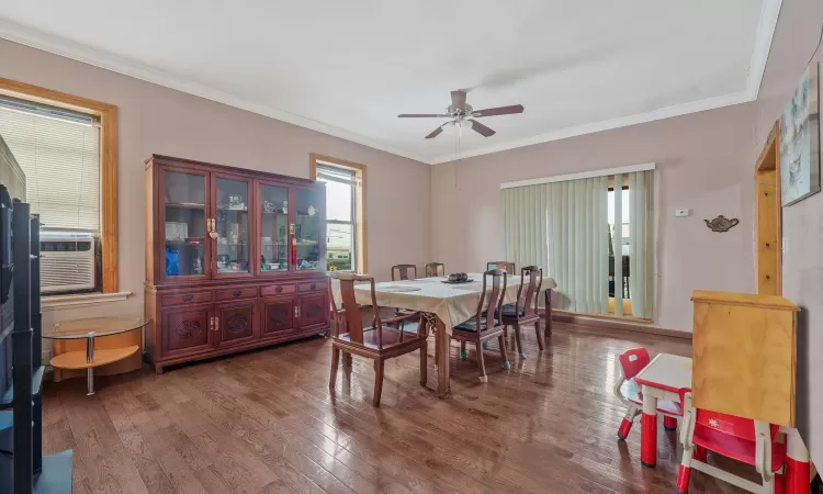 Dining area featuring ceiling fan, ornamental molding, and hardwood / wood-style flooring