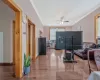 Living area with plenty of natural light, ornamental molding, ceiling fan, and wood finished floors