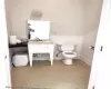 Bathroom with toilet and baseboards