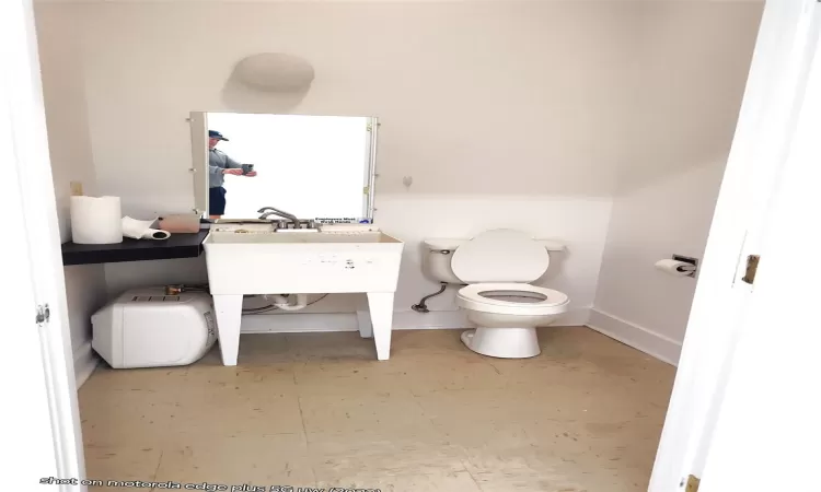 Bathroom with toilet and baseboards