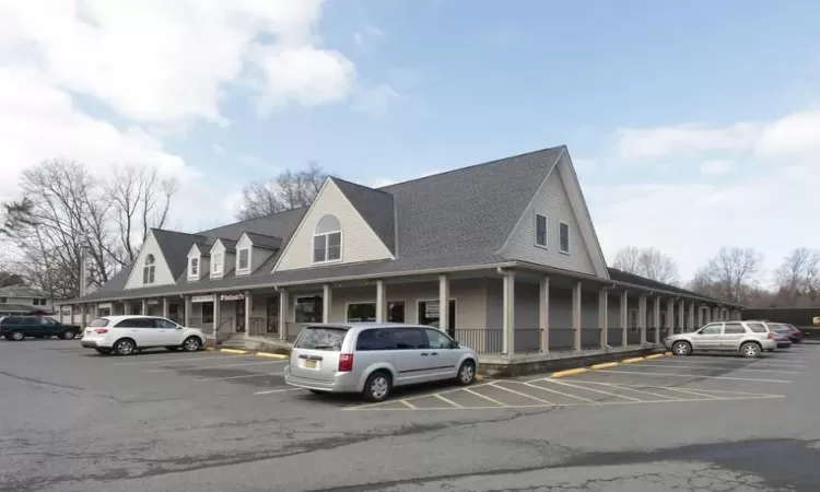 View of property with uncovered parking