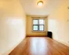 Unfurnished room featuring baseboards and wood finished floors