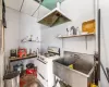 Kitchen featuring open shelves, ventilation hood, white range with gas cooktop, a paneled ceiling, and a sink