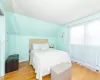 Bedroom featuring vaulted ceiling, baseboards, and light wood-type flooring