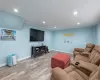 Living room featuring crown molding, recessed lighting, and wood finished floors