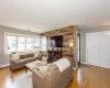 Living area featuring baseboards, an accent wall, light wood-style floors, and a baseboard radiator