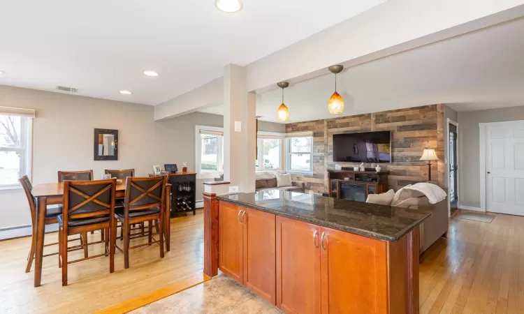 Kitchen featuring brown cabinetry, visible vents, and a healthy amount of sunlight