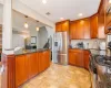 Kitchen with visible vents, backsplash, dark stone countertops, stainless steel appliances, and a sink