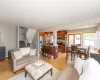 Living area with recessed lighting, stairway, a baseboard heating unit, and light wood finished floors