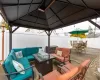 View of patio / terrace featuring outdoor dining space, a gazebo, a fenced backyard, and outdoor lounge area