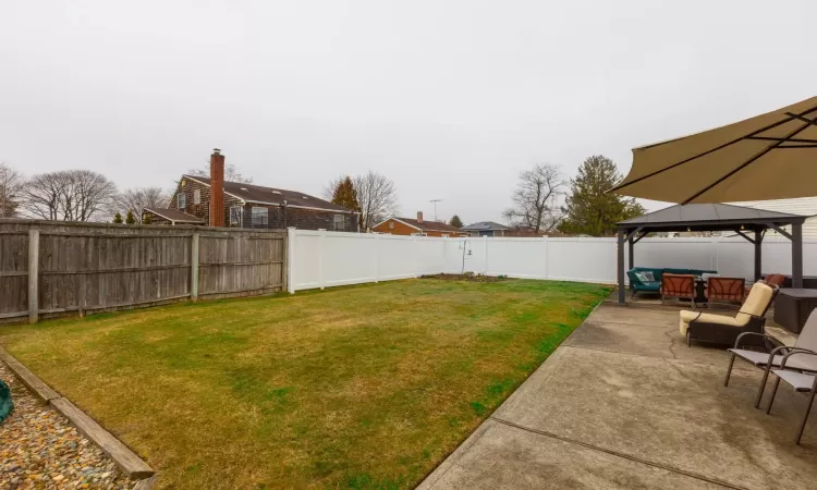 View of yard featuring a gazebo, a fenced backyard, outdoor lounge area, and a patio