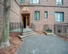 Entrance to property featuring fence and brick siding