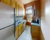 Kitchen featuring baseboards, light tile patterned flooring, a sink, stainless steel appliances, and backsplash