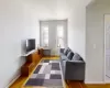 Living room featuring radiator, baseboards, and light wood-type flooring