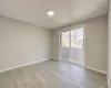 Unfurnished room featuring light wood-type flooring and baseboards